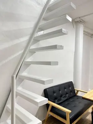a staircase with a black bench in a room at Megun Room5 in Ban Bang Phlat