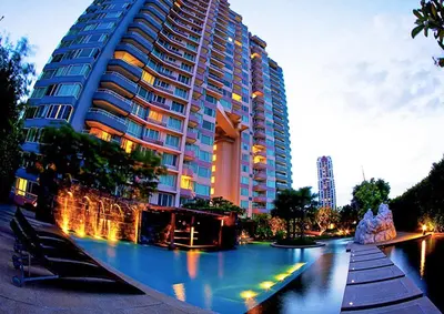 a large building with a river in front of it at Watermark Chaophraya River Condo in Bangkok