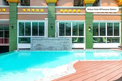 a large swimming pool in front of a building at Airbus Hotel At Phawana Station in Bangkok