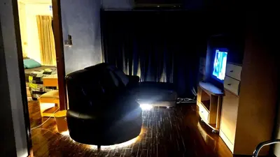 a living room with a couch and a television at River View Active 7 in Bangkok