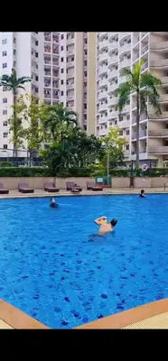 a group of people swimming in a large swimming pool at River View Active 7 in Bangkok