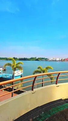 a view of a body of water with palm trees at River View Active 7 in Bangkok