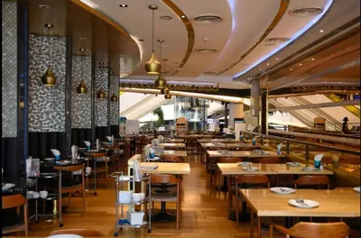 a dining room with tables and chairs in a restaurant at River View Active 7 in Bangkok