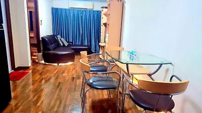 a glass table and chairs in a living room at River View Active 7 in Bangkok