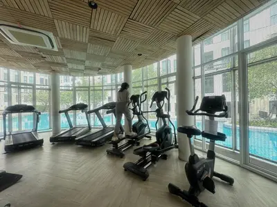 a gym with people exercising on treadmills in a building at Sunlit Nest Sukhumvit in Ban Khlong Samrong