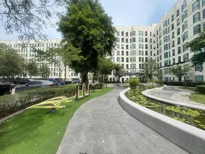 a walkway in front of a large building at Sunlit Nest Sukhumvit in Ban Khlong Samrong