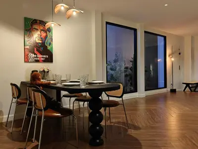 a dining room with a table and some chairs at Thonglor 4-story modern art villa Free WiFi Netflix in Bangkok