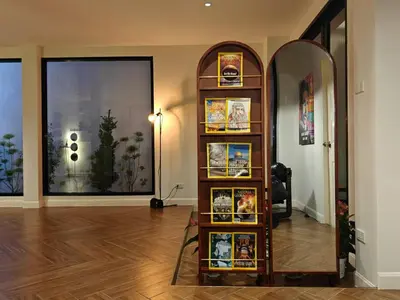 a room with a mirror and a shelf with pictures at Thonglor 4-story modern art villa Free WiFi Netflix in Bangkok