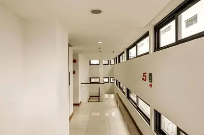 an empty hallway in a building with windows at Premier Place Bangkok in Bangkok
