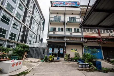 a building in the middle of a city with tall buildings at Skutan-MTB Bangchak in Bangkok