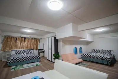 a living room with two beds and a couch at Skutan-MTB Bangchak in Bangkok