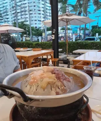 a pot of food is cooking on a grill at Popular Condo เมืองทองธานี in Thung Si Kan