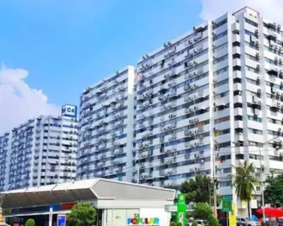 a large apartment building in front of a building at Popular Condo เมืองทองธานี in Thung Si Kan