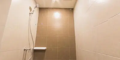 a bathroom with a shower with a shower head at Cozy apartment near Don Mueang airport in Lak Si