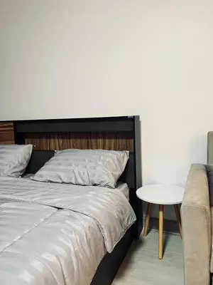 a bedroom with a bed and a table and a couch at T12 Popular Condo By hunnity 2 in Ban Bang Phang