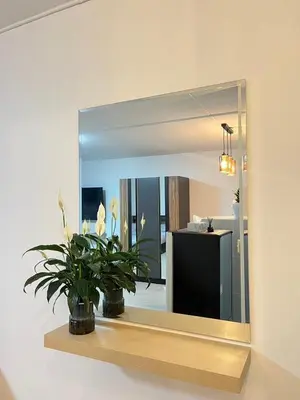 a mirror on a wall with a plant on a shelf at T12 Popular Condo By hunnity 2 in Ban Bang Phang