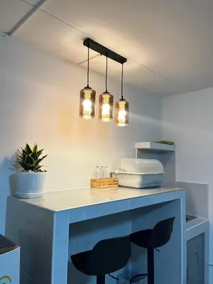 a kitchen with a blue counter with two lights at T12 Popular Condo By hunnity 2 in Ban Bang Phang