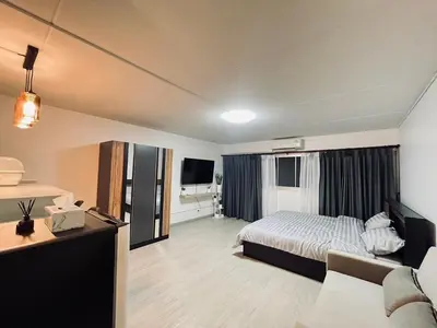 a hotel room with a bed and a television at T12 Popular Condo By hunnity 2 in Ban Bang Phang