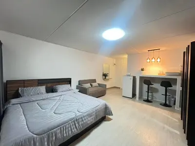 a bedroom with a large bed and a desk at T12 Popular Condo By hunnity 2 in Ban Bang Phang