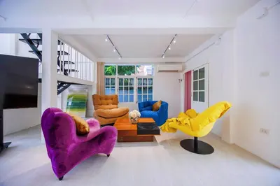 a living room with purple chairs and a couch at Fira\u5e7d\u58837\u5367\u6cf3\u6c60\u8c6a\u534e\u522b\u5885 in Sathani Khlong Tan