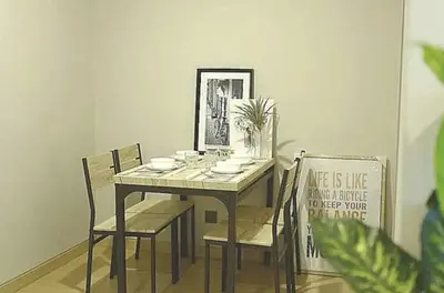 a dining room table and chairs with a sign on it at Phetchaburi - Lumpini Condo in Bangkok
