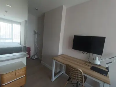 a bedroom with a desk with a television and a bed at rama9\u533a\u57df\u5730\u94c1\u8c6a\u534e\u516c\u5bd3\u51fa\u79df Metro Luxe Ratchada in Bangkok