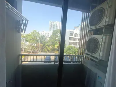 a room with a balcony with a view of a city at rama9\u533a\u57df\u5730\u94c1\u8c6a\u534e\u516c\u5bd3\u51fa\u79df Metro Luxe Ratchada in Bangkok
