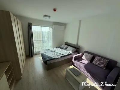 a small room with a bed and a couch at Z house Sukhumvit in Bangkok