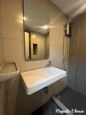 a bathroom with a white sink and a mirror at Z house Sukhumvit in Bangkok