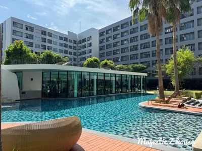 a large swimming pool in front of a building at Z house Sukhumvit in Bangkok
