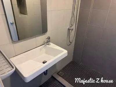 a white sink in a bathroom with a mirror at Z house Sukhumvit in Bangkok