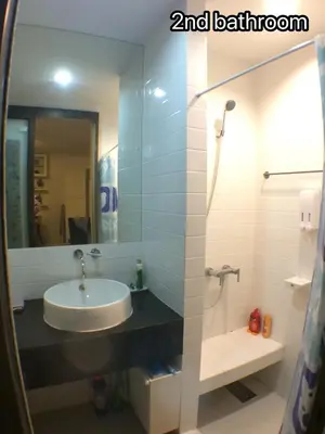 a bathroom with a sink and a shower with a mirror at PERFECT 80sqm apartment serve up to 5 \u5b8c\u7f8e\u7684\u516c\u5bd3 in Bangkok