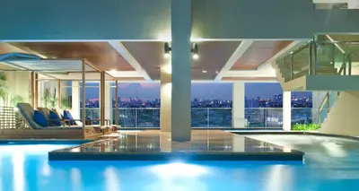 a house with a swimming pool with a view of the city at PERFECT 80sqm apartment serve up to 5 \u5b8c\u7f8e\u7684\u516c\u5bd3 in Bangkok