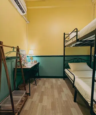 a room with two bunk beds and a desk at During Moonshine Stay in Bangkok