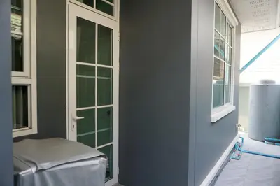 a room with a door and windows in a room at Family Friendly Home in Bangna