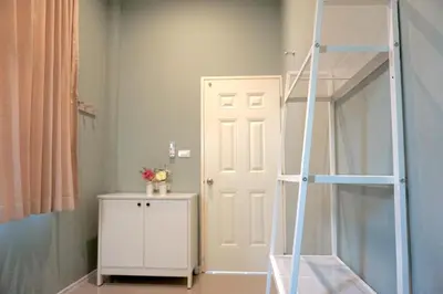 a room with a ladder next to a door at Family Friendly Home in Bangna