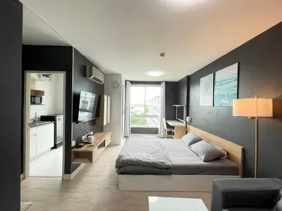 a bedroom with a bed and a living room at Studio123 at changwattana in Ban Bang Phang