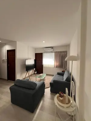 a living room with two couches and a table at Hotel Nanon Sathorn in Bangkok