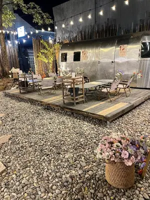 a restaurant with tables and chairs and a trailer at Hotel Nanon Sathorn in Bangkok