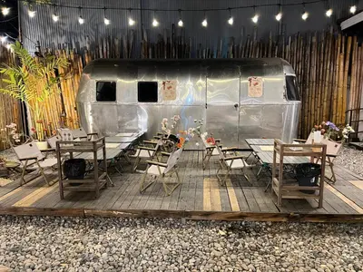 a table and chairs in front of a trailer at Hotel Nanon Sathorn in Bangkok