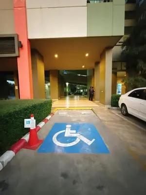 a parking lot with a handicapped sign in front of a building at 2BR - MRT Lak Song 5 Minute - Garden-Gym-Pool-wifi in Ban Khlong Khwang Klang