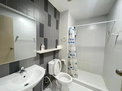 a bathroom with a white toilet and a sink at Studio16 at Changwattana in Ban Bang Phang