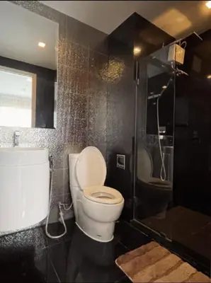 a bathroom with a toilet and a shower at Luxurious Downtown Apartment With Train Access Bts in Bangkok