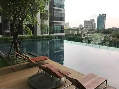 a couple of chairs sitting on top of a building at Luxurious Downtown Apartment With Train Access Bts in Bangkok