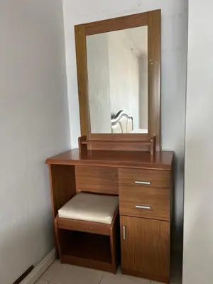 a wooden dresser with a mirror on top of it at Srivara condo Rachada in Bangkok