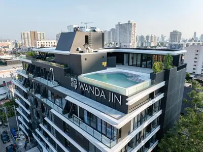a building with a swimming pool on top of it at Wanda Jin Residences The Ease Sierra Bangkok in Bangkok