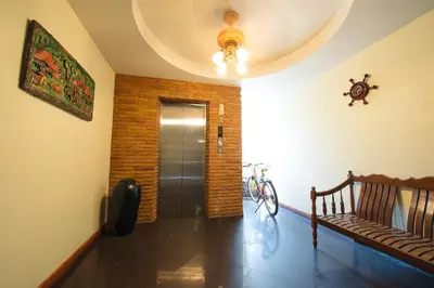 a hallway with a door and a bench in a room at Sathorn View in Bangkok