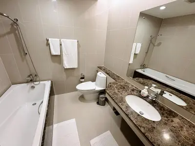 a bathroom with a sink and a toilet and a mirror at The Prime 11 Sukhumvit 11 2BR near BTS Nana in Bangkok