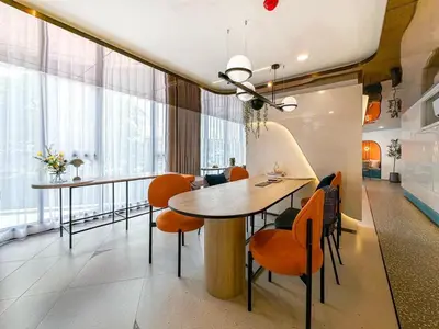 a dining room with a table and orange chairs at 1Bed Room Near Airport DMK BTS Swimming Pool Gym Monthly rental in Sathani Lak Si