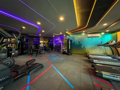 a gym with purple and blue lights on the walls at 1Bed Room Near Airport DMK BTS Swimming Pool Gym Monthly rental in Sathani Lak Si